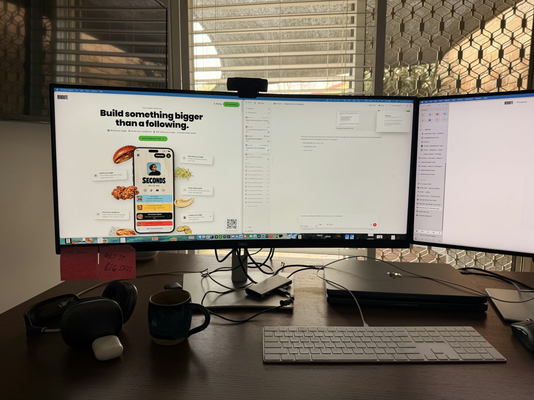 Ty’s Newcastle workspace, with Reroute open across the monitors and a coffee on the desk